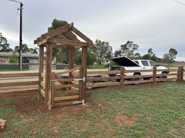 Arbour gate joined to a post and rail fence