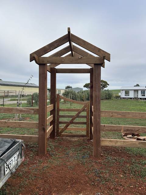 Timber arbour entrance with a gate