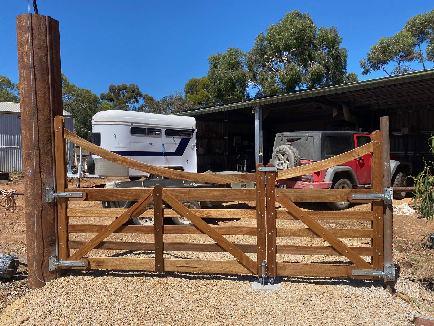 Curved-top double gates at a shed and yard entrance