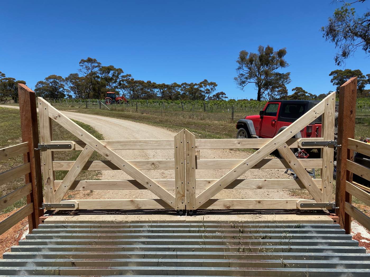 Double timber gates hung over a cattle grid