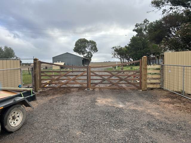 Double timber gates into a shed yard