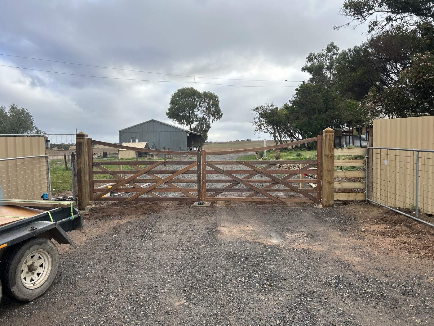 Double timber gates into a shed yard