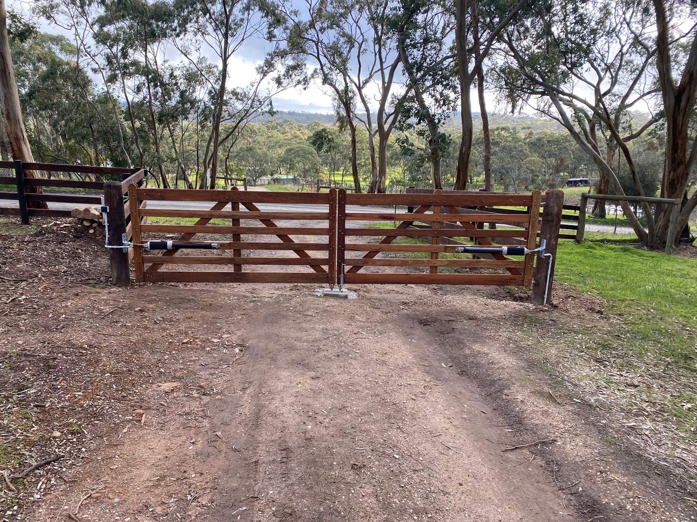 Double timber gates across a rural driveway