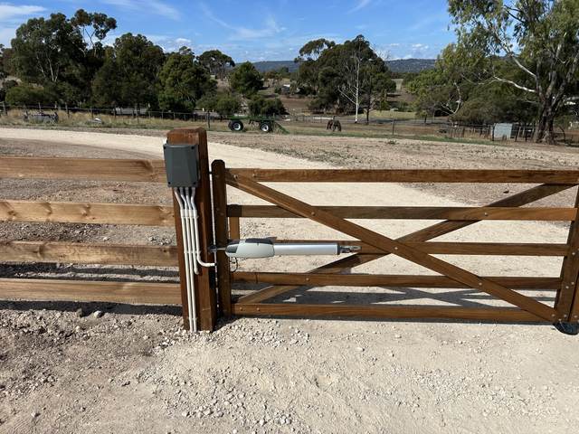 Timber gate with a motor and control box fitted