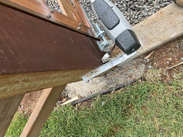 Motor arm on a timber gate
