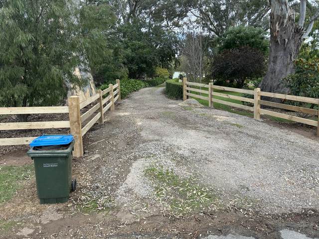 Post and rail wings at a driveway entrance