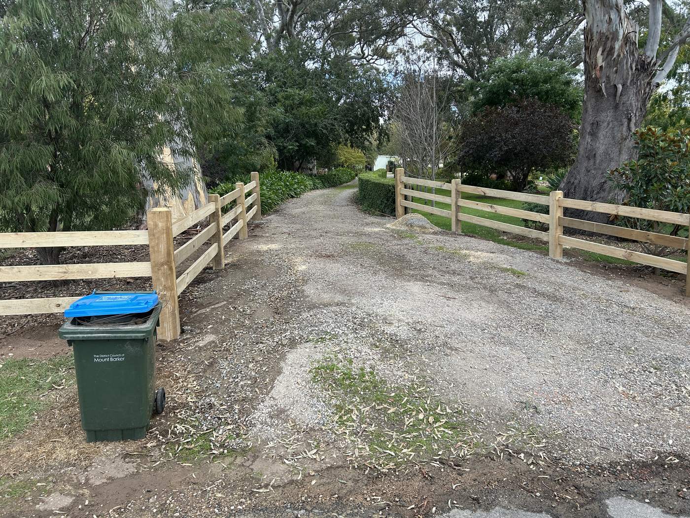 Post and rail wings at a driveway entrance