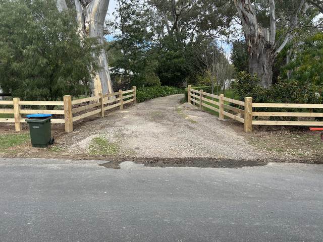 Post and rail either side of a driveway