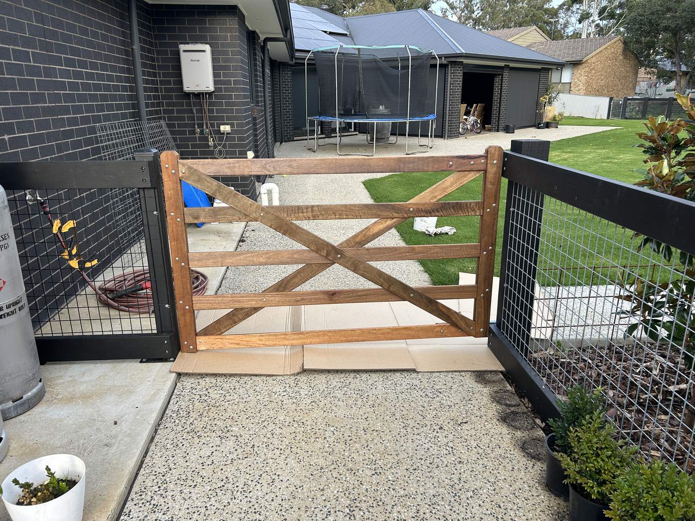 Side gate into a back yard, timber with a steel mesh panel beside it
