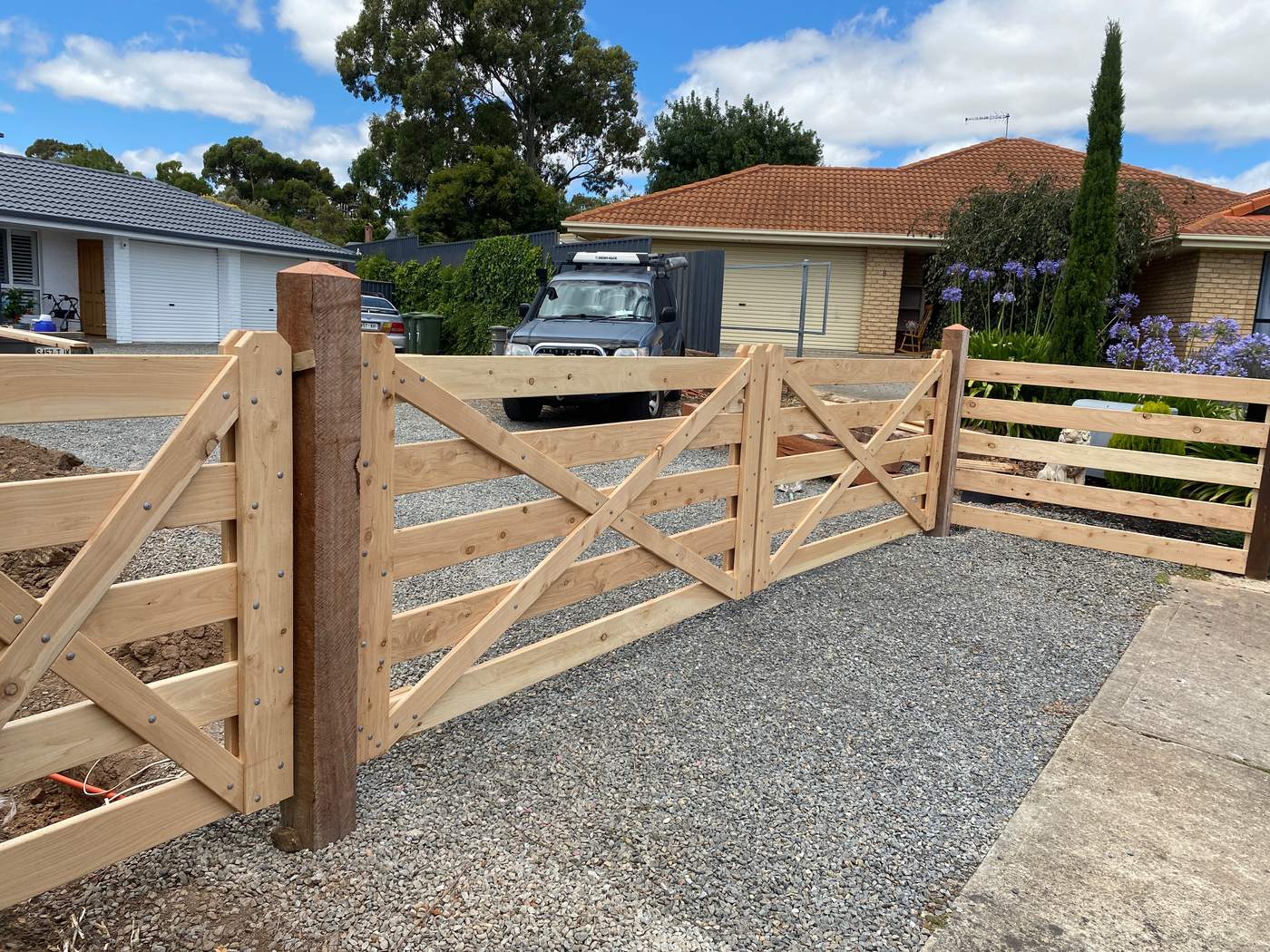 Town driveway gates with matching post and rail