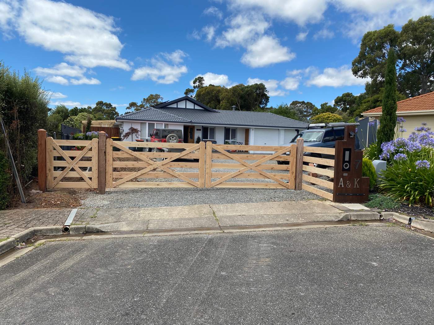 Double gates and post and rail on a town driveway