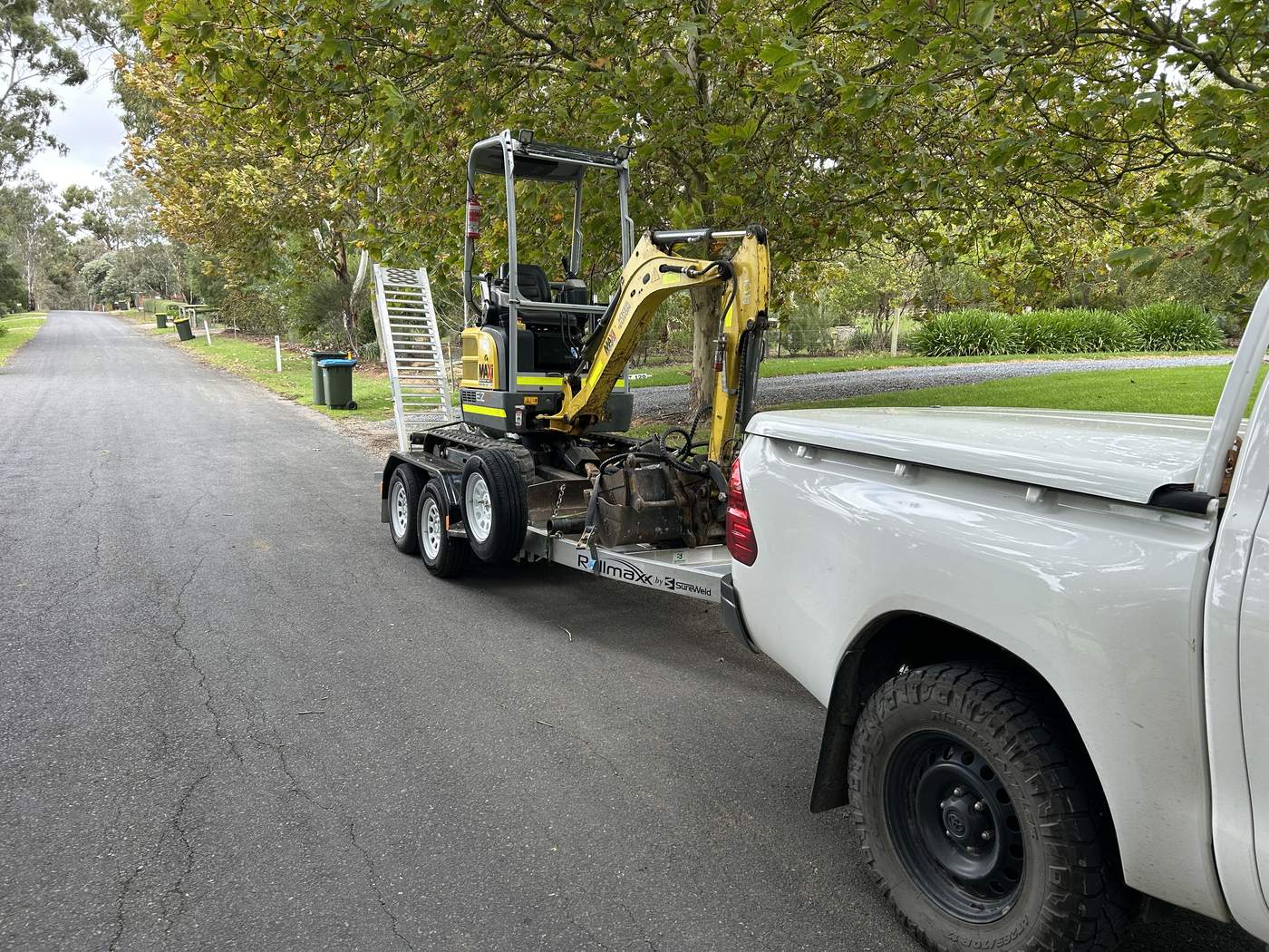 Ute, trailer and mini excavator on a job